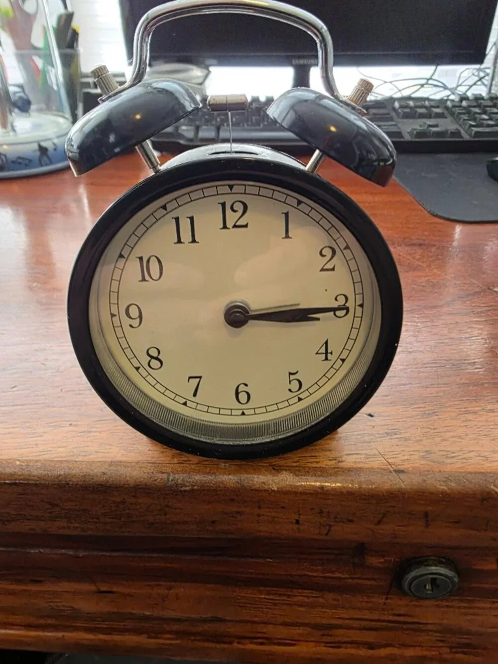 IKEA BLACK WIND UP CLOCK WITH BELLS ON TOP OF CLOCK